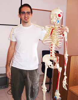 Dr. Adrian Garcia, medical student at Trinity SoM with Mr. Bones